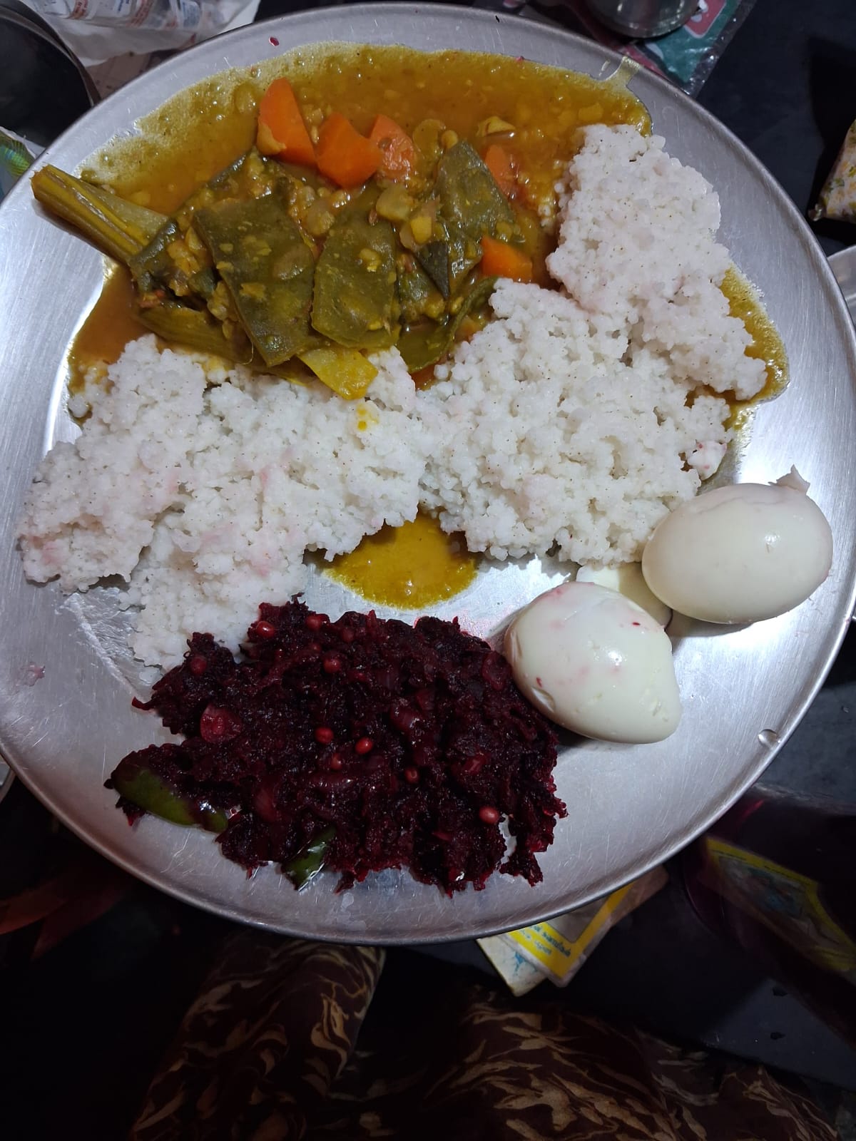 Chellammal's meal plate with vegetable kuzhambu with drumstick and carrot, beetroot poriyal, boiled eggs and rice