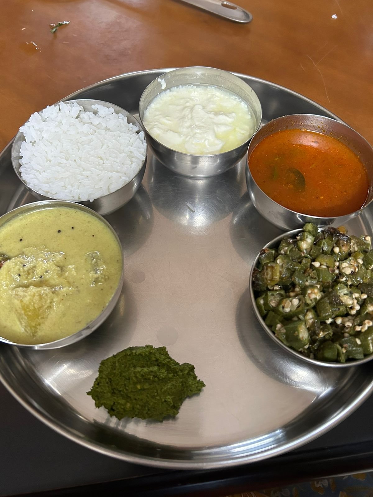 Vegetarian meal with structured portions of grain, dal, vegetable and curd